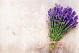 Fototapeta Lawenda - Lavender flowers, bouquet on rustic background, overhead.