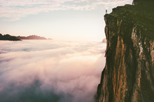 Traveler Standing On Cliff Edge Mountain Top Above Sunset Clouds Travel Adventure Lifestyle Summer Journey Vacations