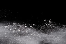 Launched White Powder, Isolated On Black Background.