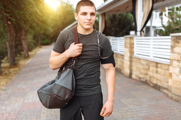 a man goes to training, an athlete with a bag in his hands, a morning run