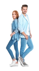 Wall Mural - Young couple in stylish jeans on white background