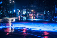 Cars Driving On Wet Road In The Rain And Colored Lights Reflected On The Wet Asphalt Road