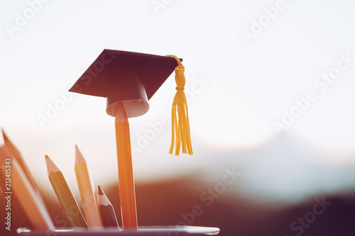 Cuadros en Lienzo Education Graduate study concept: Black Graduation hat on pencils, blur of view outdoor