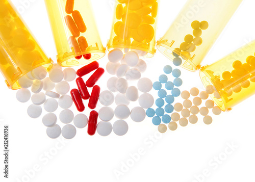 Fotografering Flat lay top view many medication bottles spilled onto isolated surface