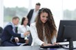 © ASDF - Manager woman sitting behind a Desk