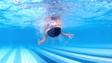 Teenager Boy Diving And Rolling Underwater In The Swimming Pool