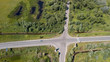 © savantermedia - Drone Photo of the Crossroad Between Trees in Colorful Early Spring - Top down view with Freshly Cultivated Field on the one side and Dandelion Field on the Other Side