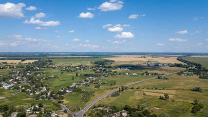 Wall Mural - aerial view of a house in a scenic countryside hills on a sunny day