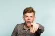 © golubovy - angry mental man screaming and pointing a finger. crazy infuriated berserk person. portrait of a young guy on light background. emotion facial expression. feelings and people reaction.