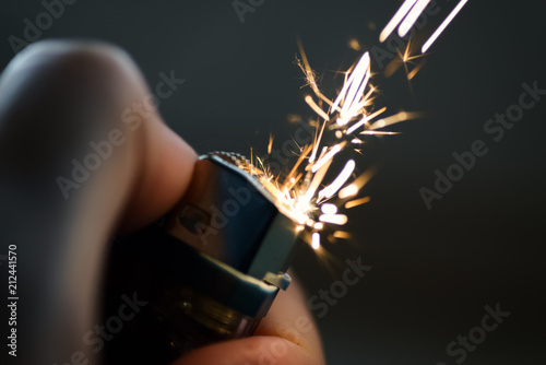 Cuadros en Lienzo Lighters with flame sparking on dark background