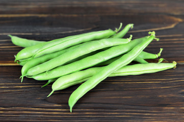 Wall Mural - Green beans on wooden background