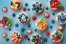 Colorful Berry Tartlets Or Cake For Kitchen Pattern. Pastry Dessert From Above.