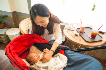korean young mother looking after her baby
