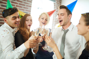 Poster - Several excited young people making birthday toast for one of them at home party