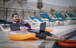 © katiekk2 - middle aged arab man by a pool working  in his business suit
