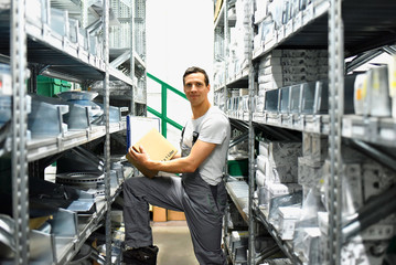 employees of a car repair shop in a warehouse for spare parts