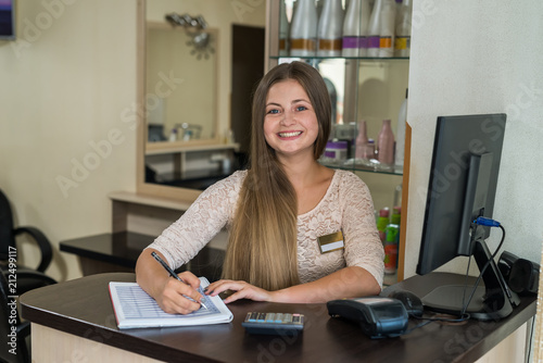 Cuadros en Lienzo The beauty salon administrator is recording clients