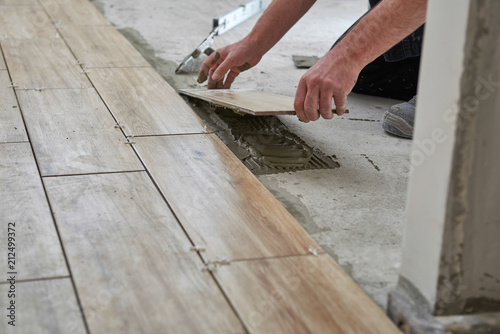 Laying Wood Effect Tiles On The Floor Worker This Stock Photo And Explore Similar Images At Adobe - Laying Wood Look Floor Tiles Laying Wood Effect Tiles On The Floor Worker This Stock Photo And Explore Similar Images At Adobe - Laying Wood Look Floor Tiles
