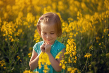 Cute Portrait Little Child On Yellow Field In Sunny Summer Day
