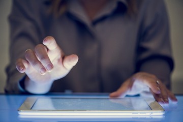 Hands holding using digital tablet on a cyber space table