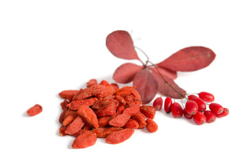 Wall Mural - Branch of ripe red barberries and dried goji berries isolated on white background