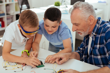 Wall Mural - new technology. happy joyful children studying together while having a science lesson