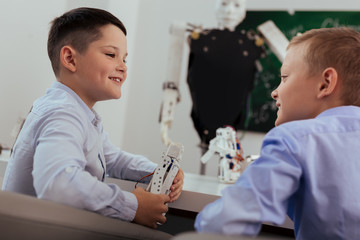 Wall Mural - school break. happy positive boy smiling while talking to his friend during a school break
