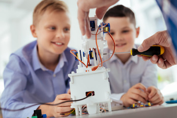 modern electronics. selective focus of a white robot being built during a science class
