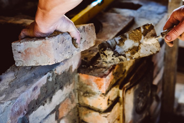 Restoration repair of the old village furnace. Bricklaying.