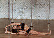 Girl performs stretching doing a leg split on the floor before pole dance training
