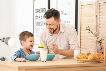 Sticker - Father and son having breakfast with milk at table