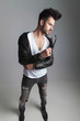 © Viorel Sima - man in leather jacket stands and looks down to side