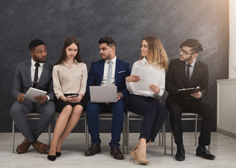 Group of business people sitting with gadgets