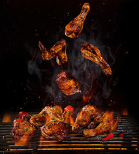 Chicken Legs And Wings On The Grill With Flames