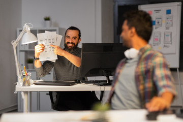 Sticker - business, deadline and web design people concept - happy creative man showing papers to colleague at night office