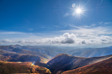 In the top of mountain. Sun shining in the sky.