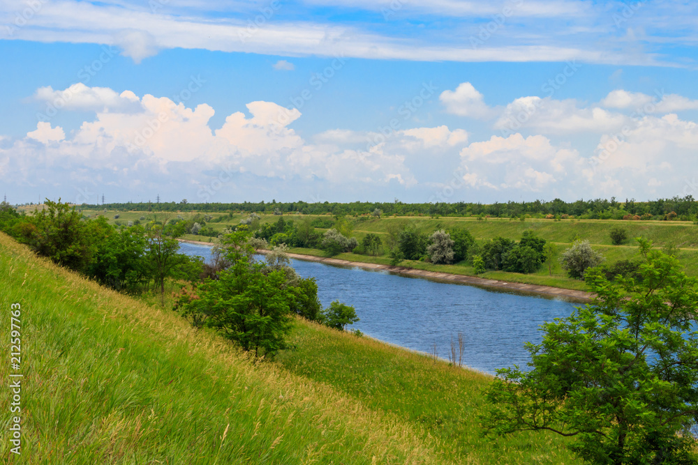 View on the irrigation canal on summer - obrazy, fototapety, plakaty 