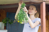 Young woman hang herbs to dry