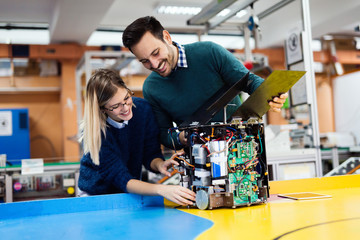 Young students of robotics working on project