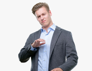 Sticker - Young handsome blond business man disgusted expression, displeased and fearful doing disgust face because aversion reaction. With hands raised. Annoying concept.