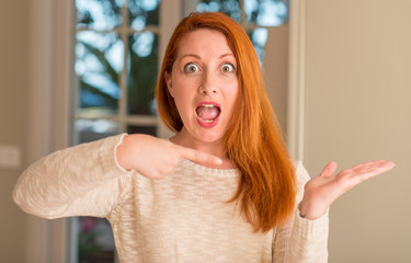 Sticker - Redhead woman at home very happy pointing with hand and finger