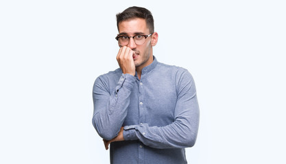 Wall Mural - Handsome young elegant man wearing glasses looking stressed and nervous with hands on mouth biting nails. Anxiety problem.