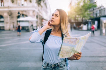 Wall Mural - Young beautiful female traveler lost in the city