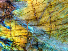 Amazing Colorful Texture Of Iridescence Labradorite Mineral Gemstone Background Macro Close-up. Beautiful Reflective Shiny Crystal
