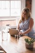 © Wavebreak Media - Businesswoman using a laptop while sitting in office