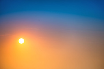 Wall Mural - sunset in the sky with big sun, blue, orange and red dramatic colors