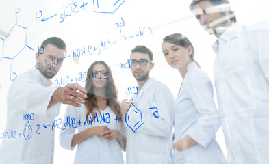 in the background image group laboratory scientists discussing their research