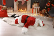 © New Africa - Authentic Santa Claus lying on floor indoors