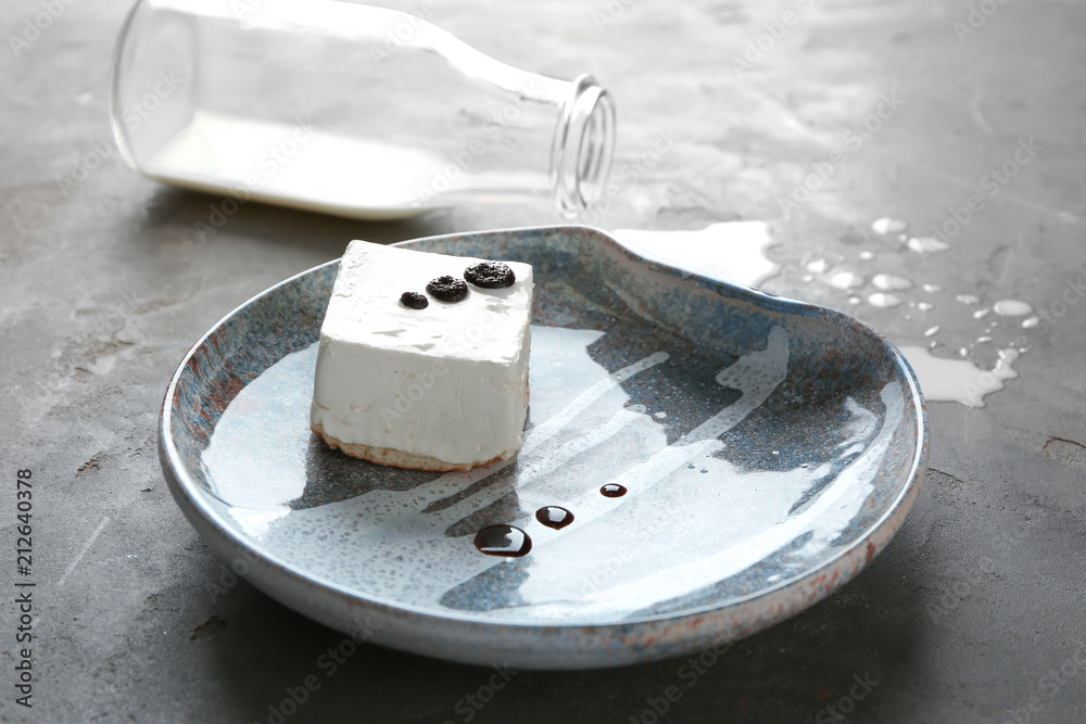 Composition with tasty souffle cake and milk on grey background