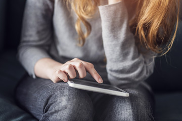 Wall Mural - Girl looking at a tablet